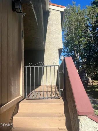 a view of balcony with wooden floor and fence