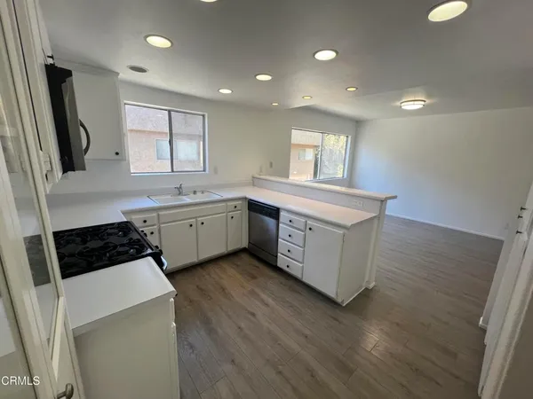 a kitchen with a sink stove and cabinets