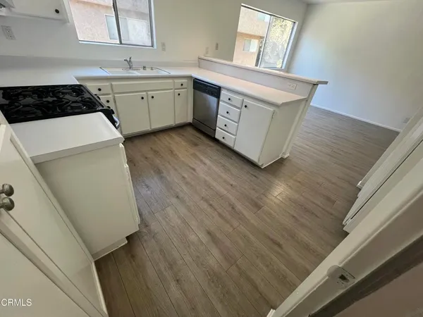 a kitchen with a sink a stove and cabinets