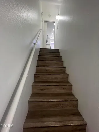 a view of a room with wooden floor and stairs