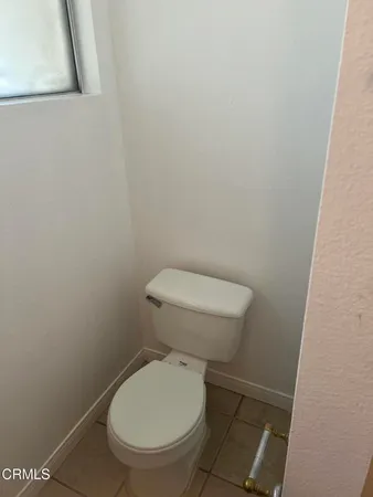 a bathroom with a granite countertop toilet and a shower