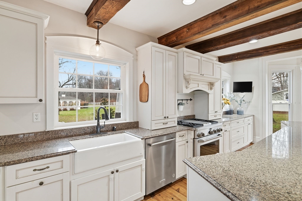 271 North Grand Street Suffield, CT 06093 - Photo 16 of 42 a kitchen with white cabinets and appliances