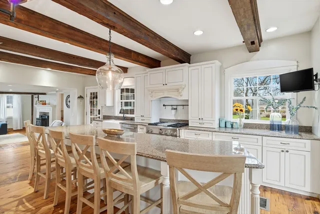 a kitchen with stainless steel appliances kitchen island granite countertop a stove and cabinets