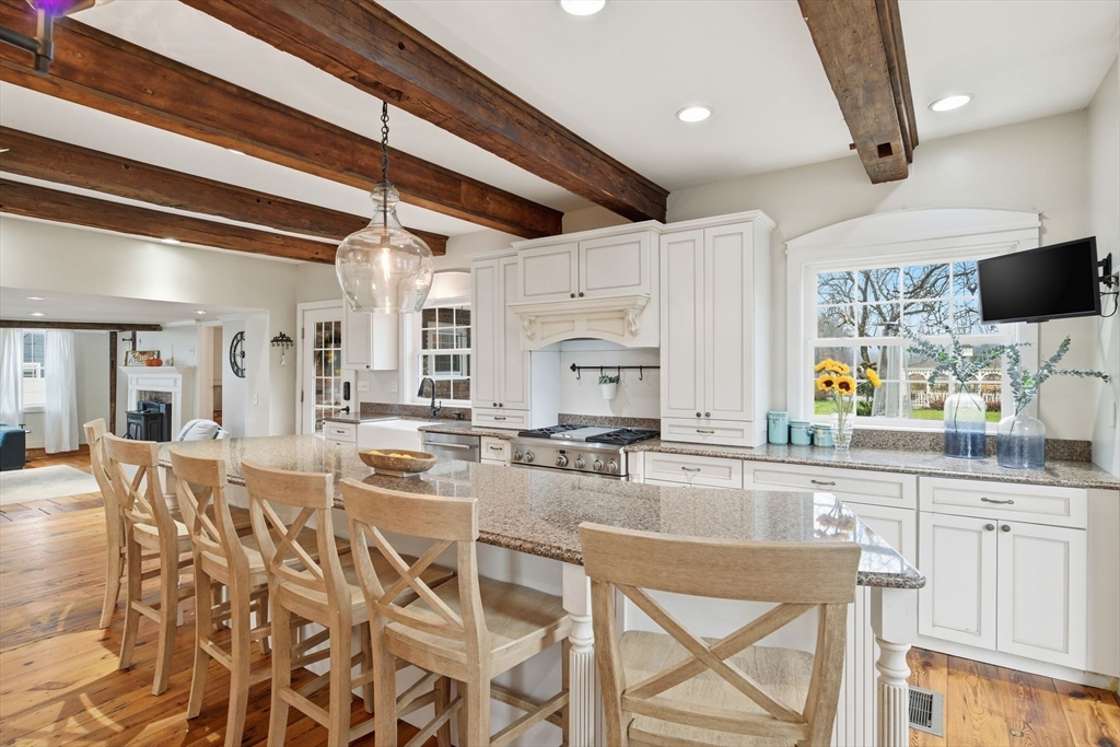 271 North Grand Street Suffield, CT 06093 - Photo 17 of 42 a kitchen with stainless steel appliances kitchen island granite countertop a stove and cabinets