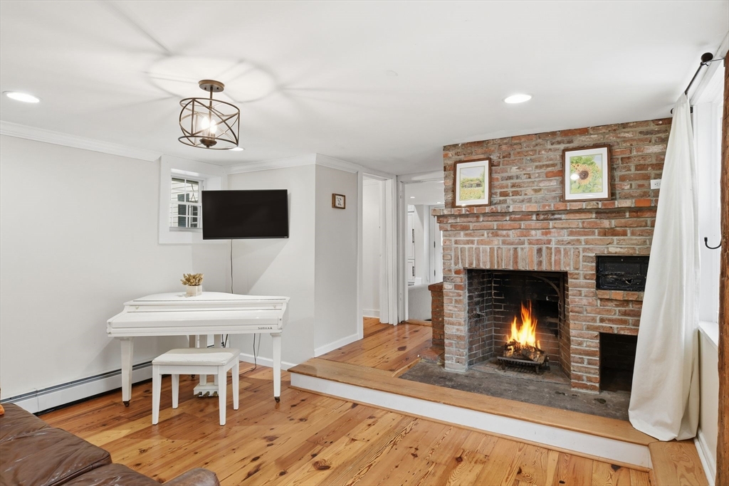 271 North Grand Street Suffield, CT 06093 - Photo 21 of 42 a living room with furniture a fireplace and a flat screen tv