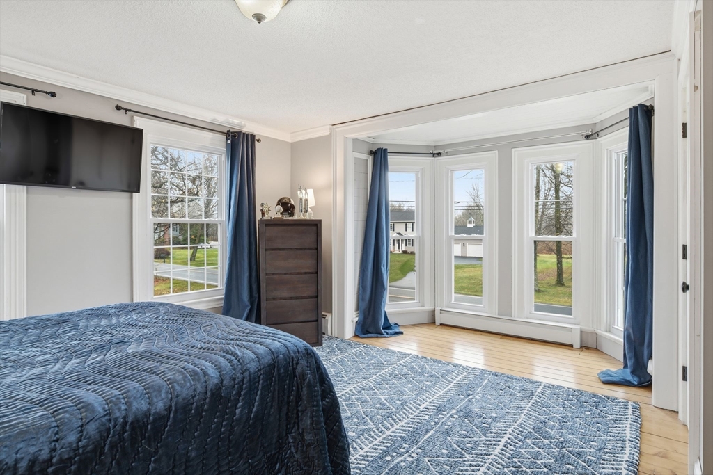 271 North Grand Street Suffield, CT 06093 - Photo 25 of 42 a bed sitting in a spacious bedroom next to a window