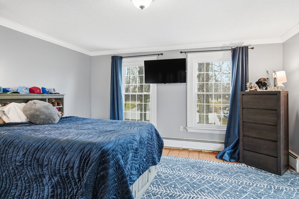 271 North Grand Street Suffield, CT 06093 - Photo 26 of 42 a bedroom with a bed and wooden floor