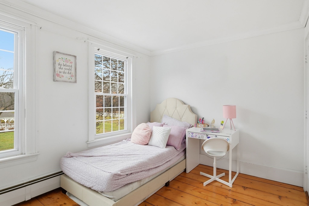 271 North Grand Street Suffield, CT 06093 - Photo 28 of 42 a bedroom with a bed and wooden floor
