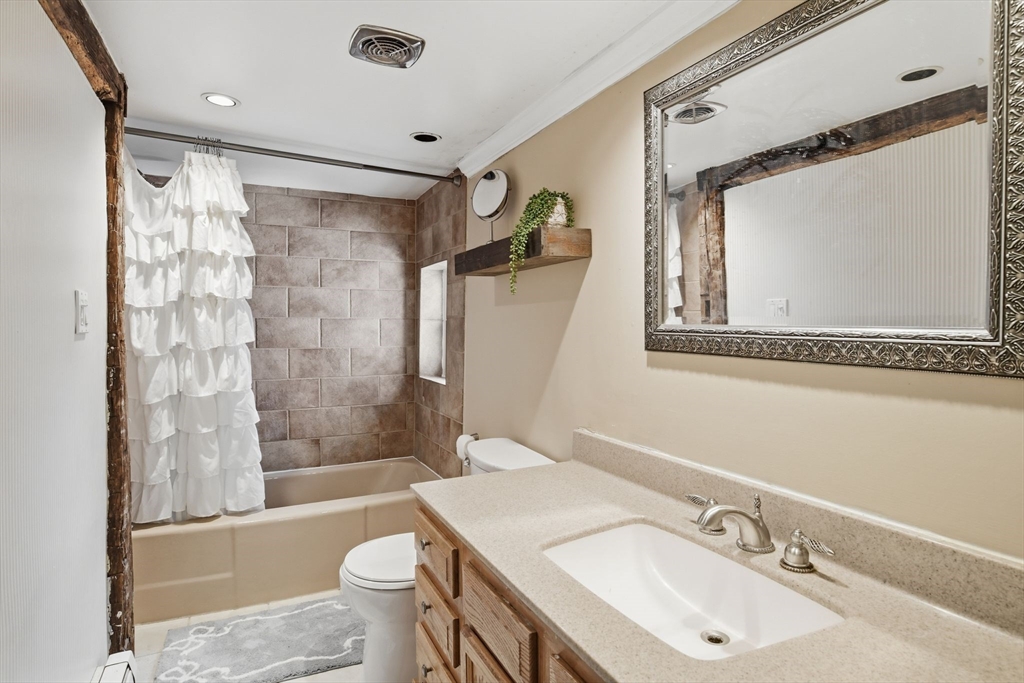 271 North Grand Street Suffield, CT 06093 - Photo 30 of 42 a bathroom with a sink mirror toilet and bathtub