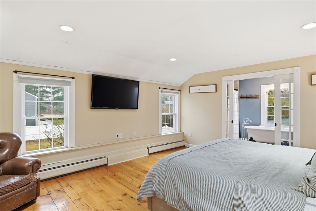 271 North Grand Street Suffield, CT 06093 - Photo 33 of 42 a bedroom with a large bed and a flat screen tv