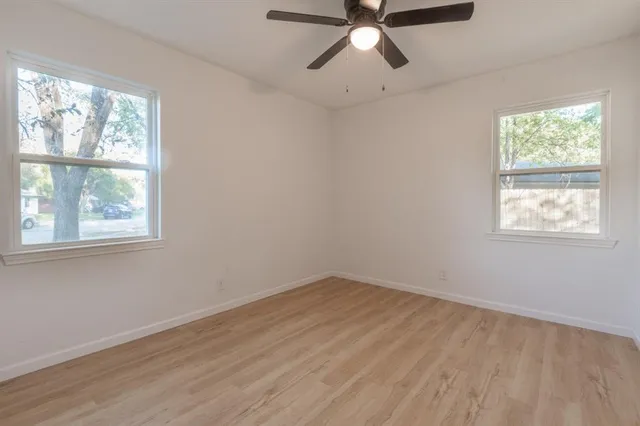 a view of a room with wooden floor and windows