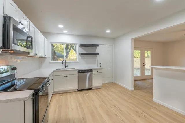 a kitchen with a sink stove and cabinets