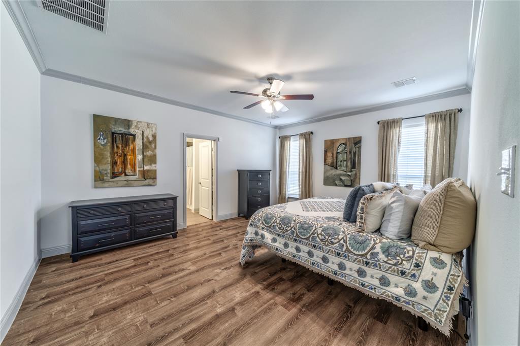 201 Brookview Drive Lavon, TX 75166 - Photo 21 of 33 a bedroom with a bed and wooden floor