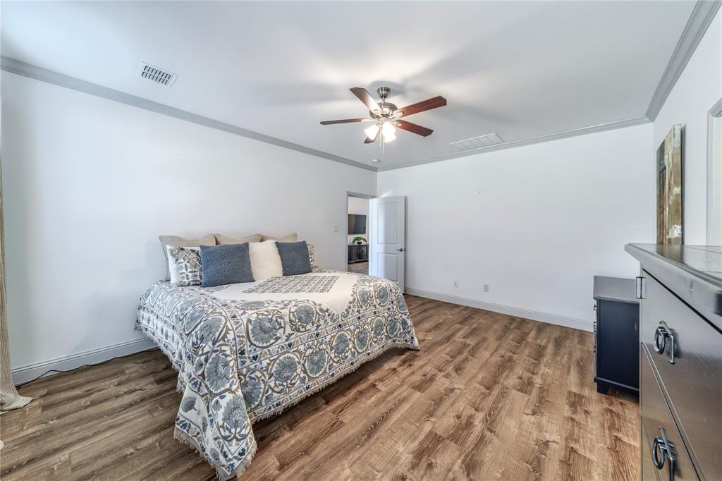 201 Brookview Drive Lavon, TX 75166 - Photo 22 of 33 a bedroom with a bed and a flat screen tv