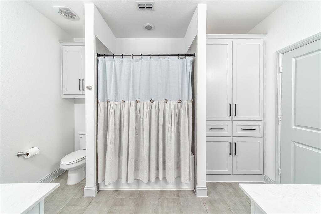 201 Brookview Drive Lavon, TX 75166 - Photo 25 of 33 a bathroom with a toilet a sink and a shower