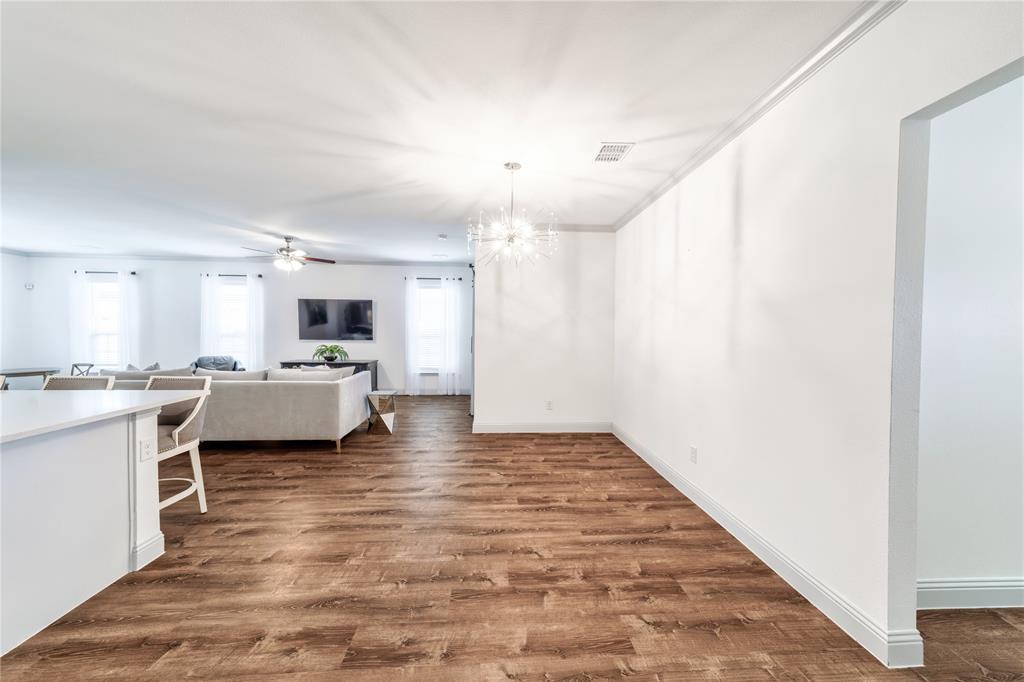 201 Brookview Drive Lavon, TX 75166 - Photo 4 of 33 a large white kitchen with a stove a sink dishwasher and a refrigerator with wooden floor