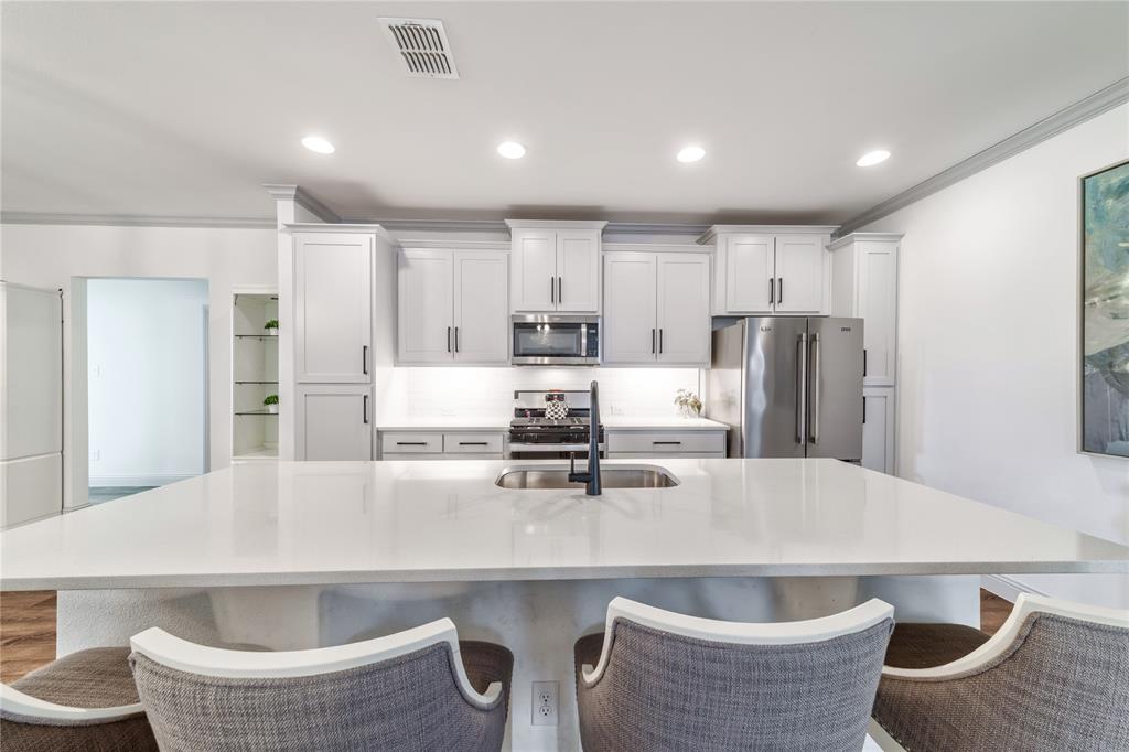 201 Brookview Drive Lavon, TX 75166 - Photo 7 of 33 a kitchen with refrigerator and chairs