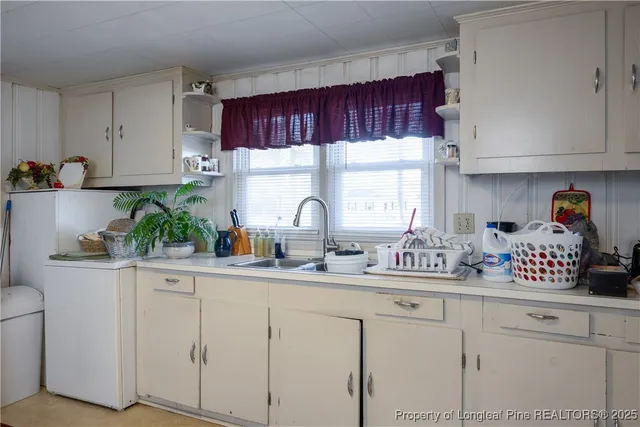 a kitchen with stainless steel appliances white cabinets and a sink