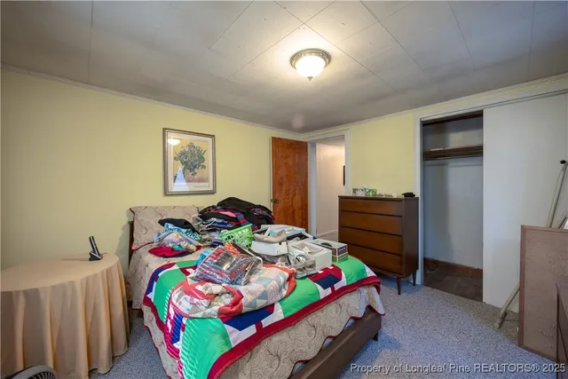 a bedroom with a bed and a dresser in it