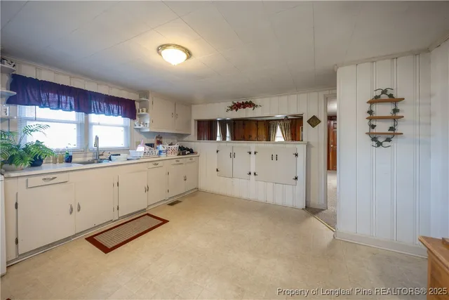 a kitchen with cabinets and window