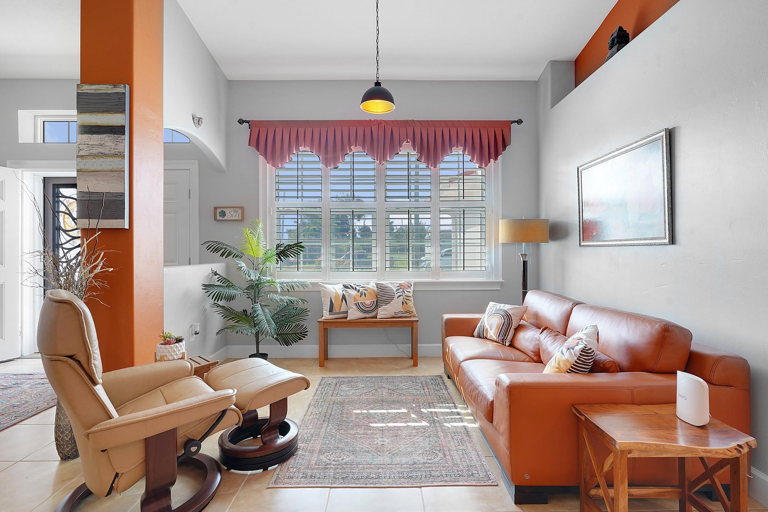 121 Harrison Road Daytona Beach, FL 32118 - Photo 12 of 48 a living room with furniture a chandelier and a dining table