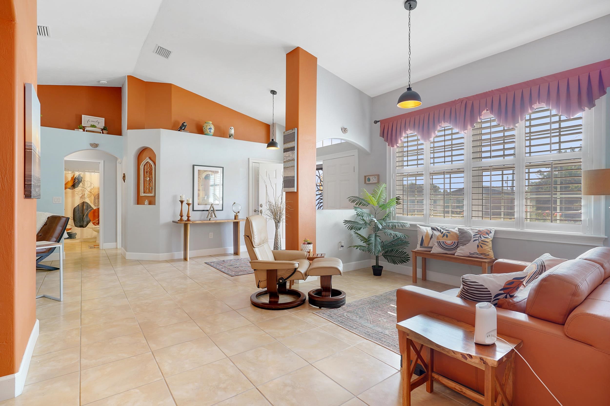 121 Harrison Road Daytona Beach, FL 32118 - Photo 13 of 48 a living room with furniture a window and a flat screen tv