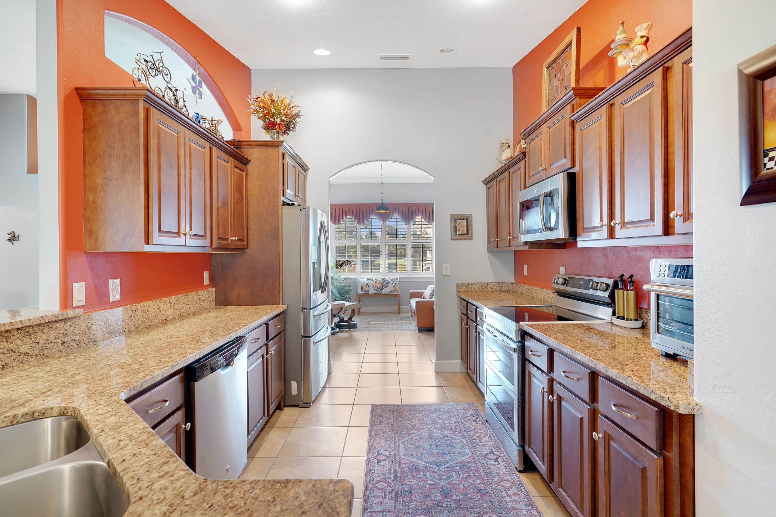 121 Harrison Road Daytona Beach, FL 32118 - Photo 16 of 48 a kitchen with stainless steel appliances granite countertop a stove and a sink