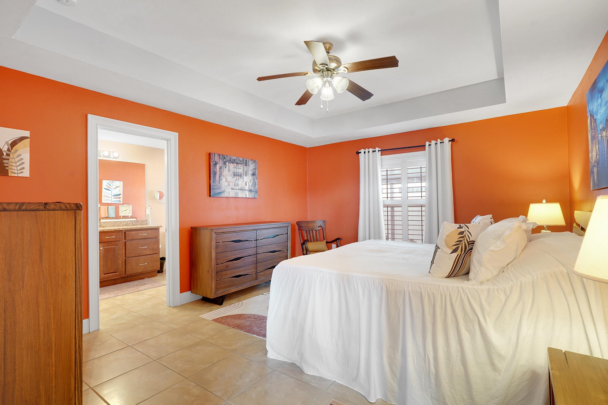 121 Harrison Road Daytona Beach, FL 32118 - Photo 18 of 48 a bedroom with a bed and a chandelier