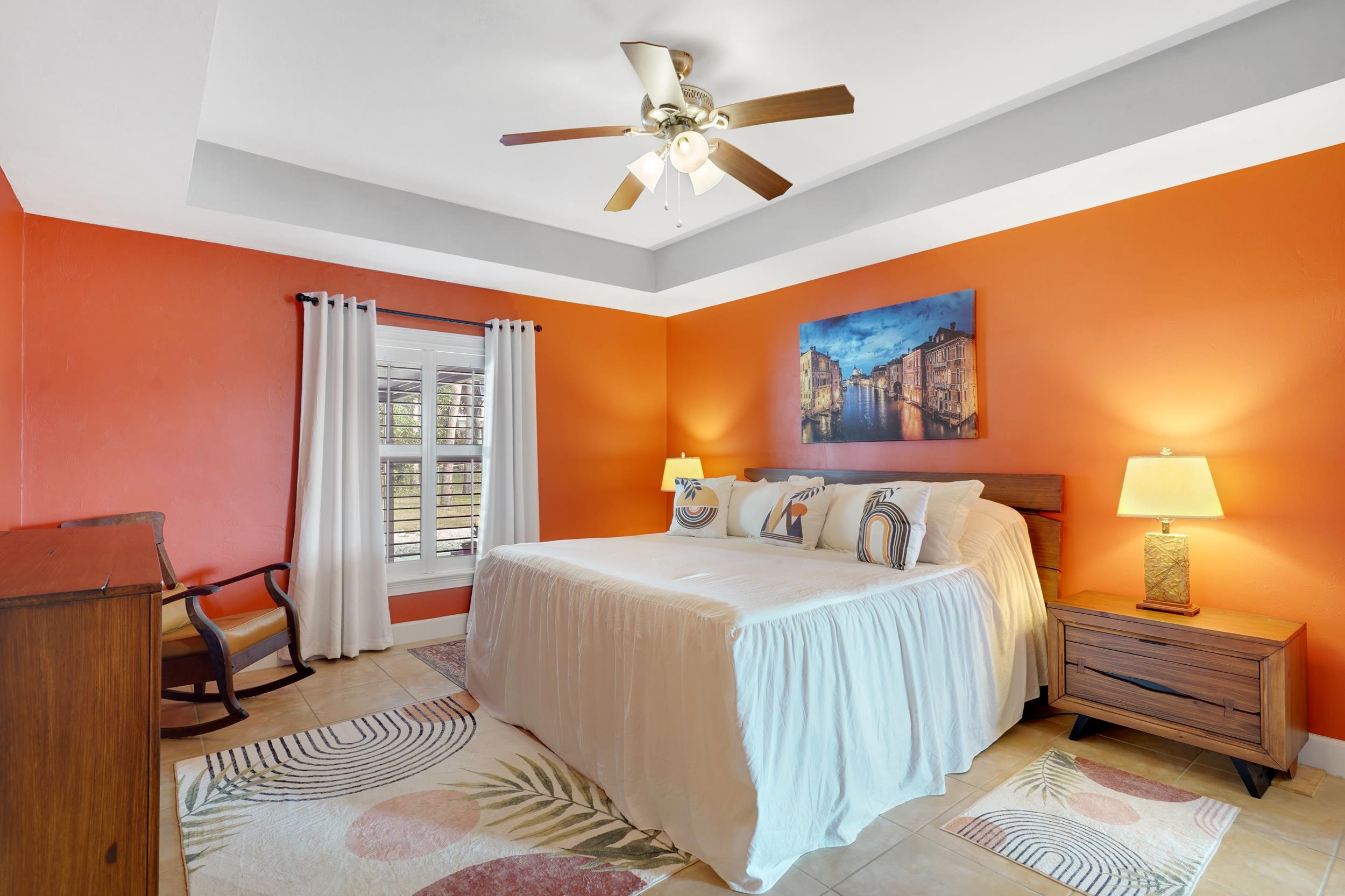 121 Harrison Road Daytona Beach, FL 32118 - Photo 19 of 48 a bedroom with a bed and a chandelier