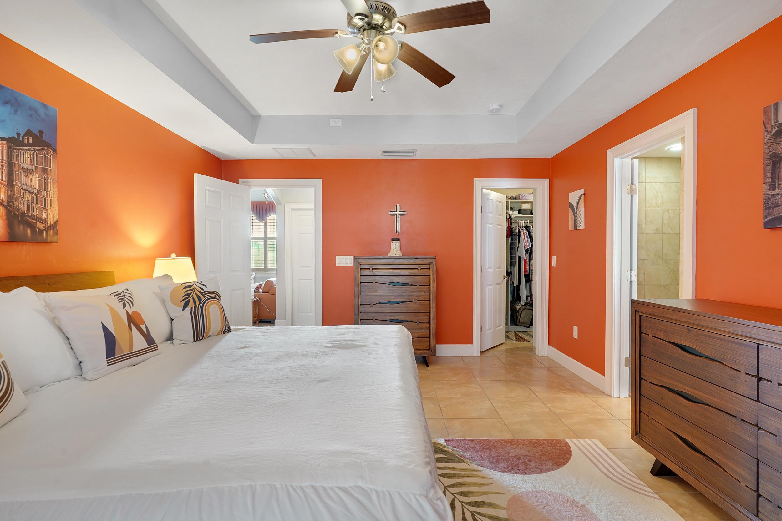 121 Harrison Road Daytona Beach, FL 32118 - Photo 20 of 48 a bedroom with a large bed and a chandelier