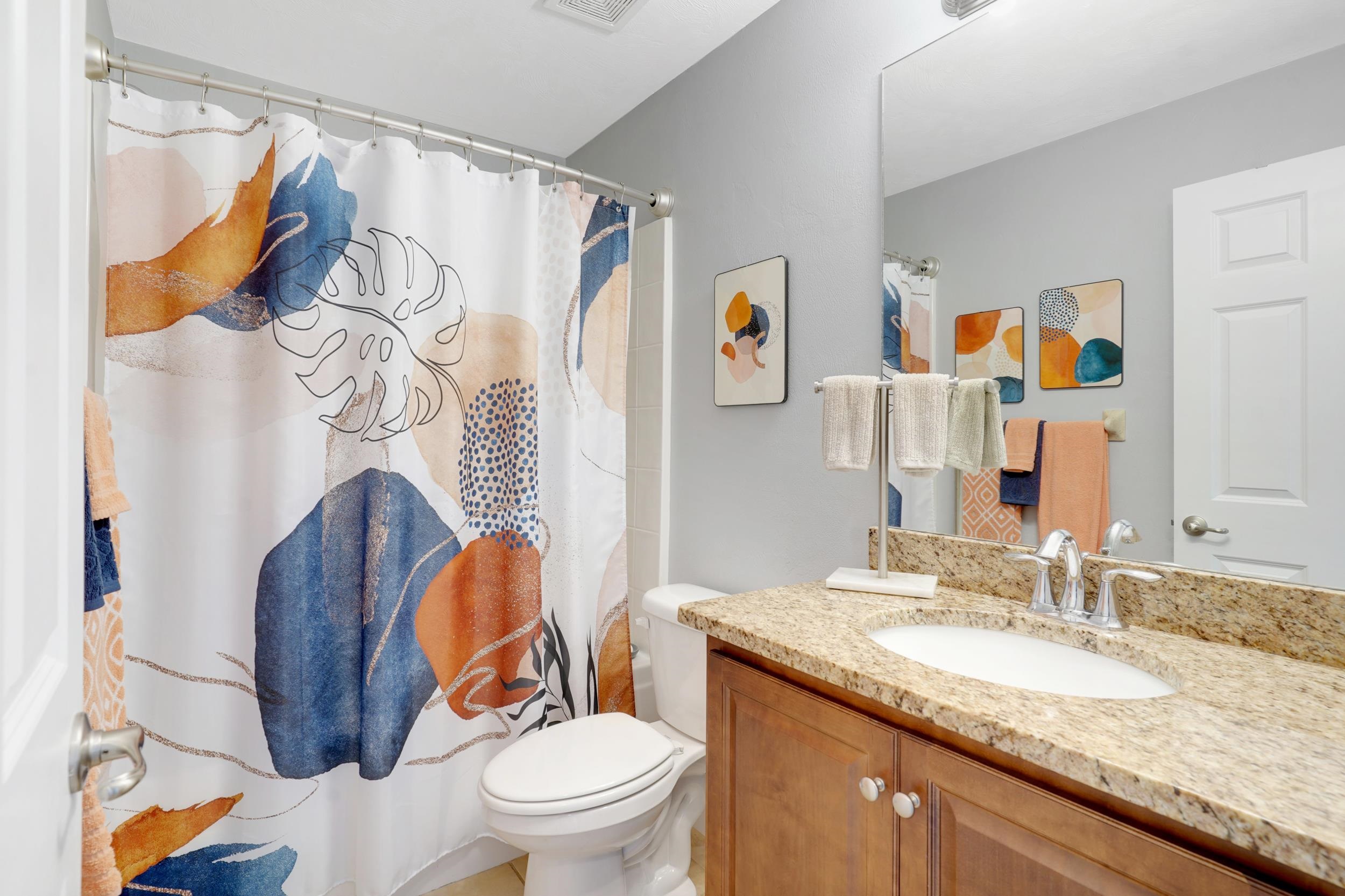 121 Harrison Road Daytona Beach, FL 32118 - Photo 26 of 48 a bathroom with a granite countertop toilet sink and mirror