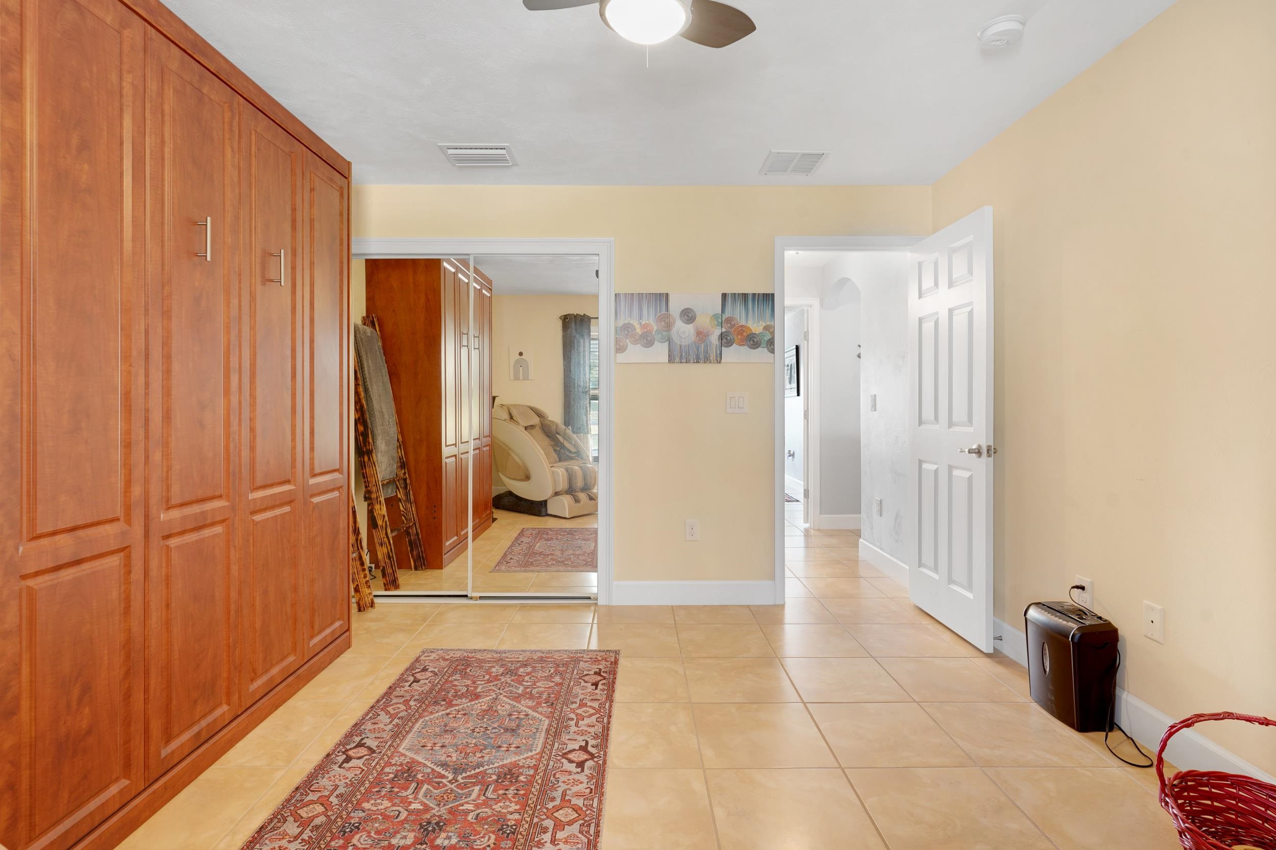 121 Harrison Road Daytona Beach, FL 32118 - Photo 28 of 48 a view of a hallway with a refrigerator and cabinets