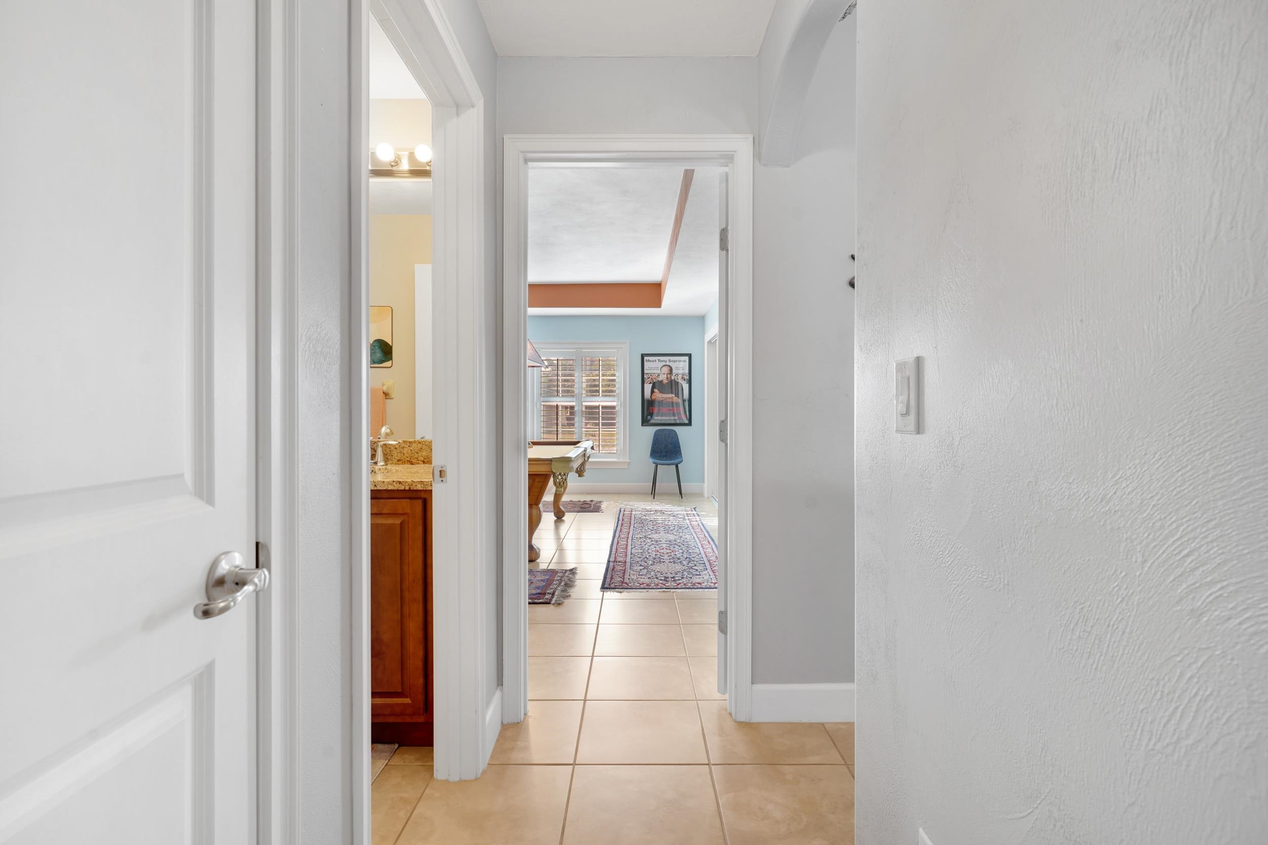 121 Harrison Road Daytona Beach, FL 32118 - Photo 29 of 48 a view of a hallway with wooden floor and a bathroom