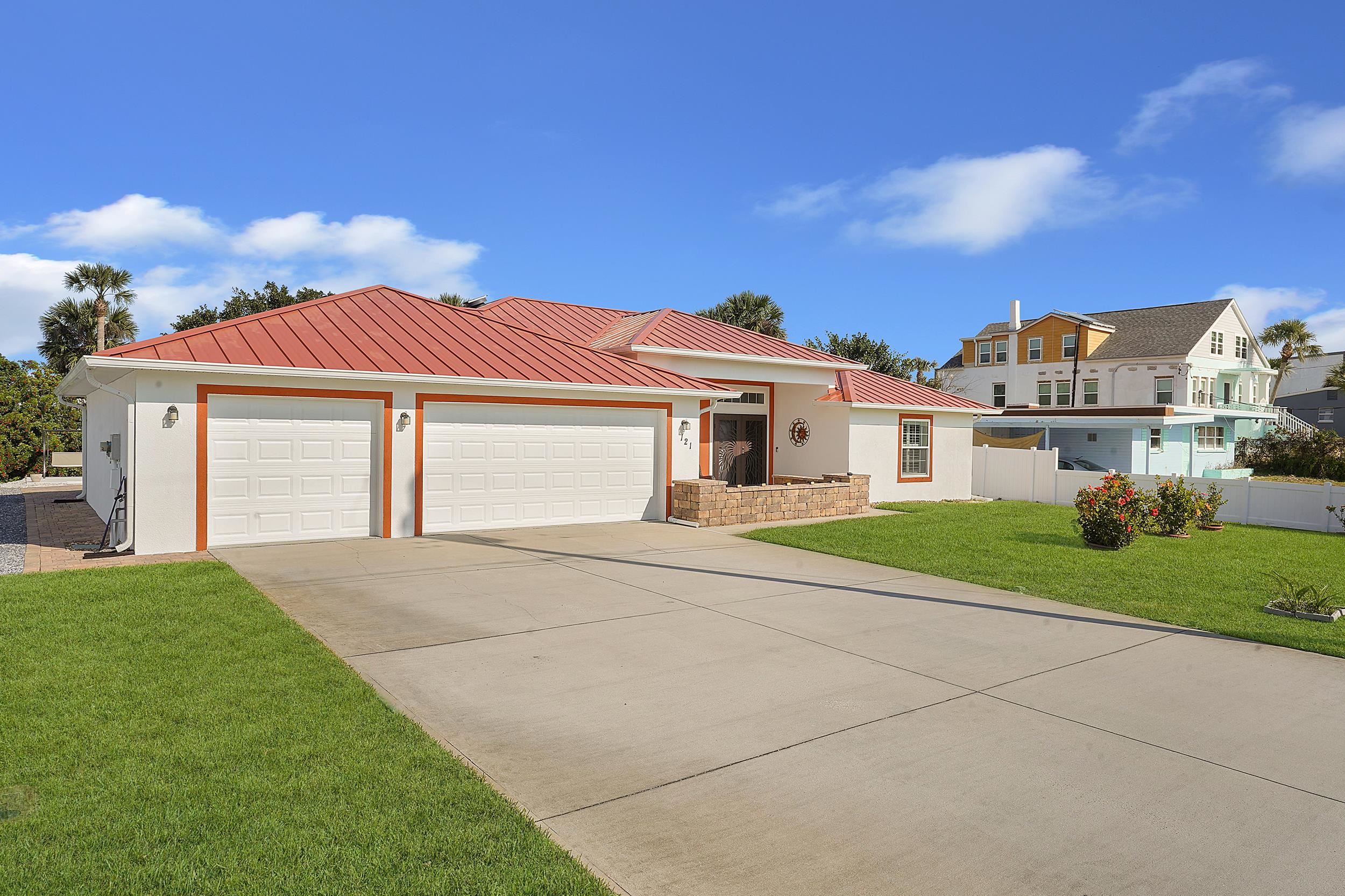 121 Harrison Road Daytona Beach, FL 32118 - Photo 3 of 48 a view of a big house with a big yard and large trees