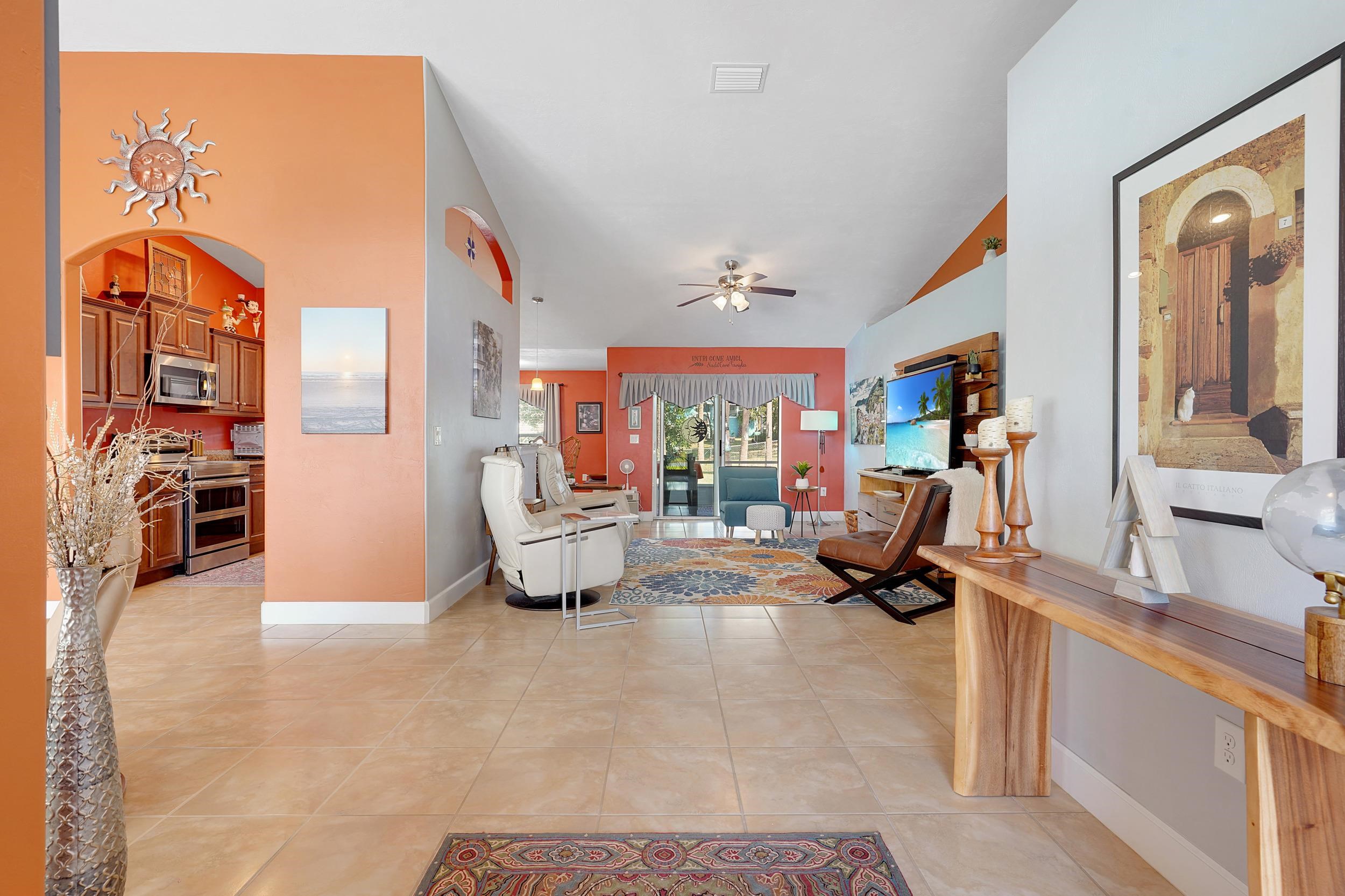 121 Harrison Road Daytona Beach, FL 32118 - Photo 6 of 48 a living room with furniture gym equipment and a large window