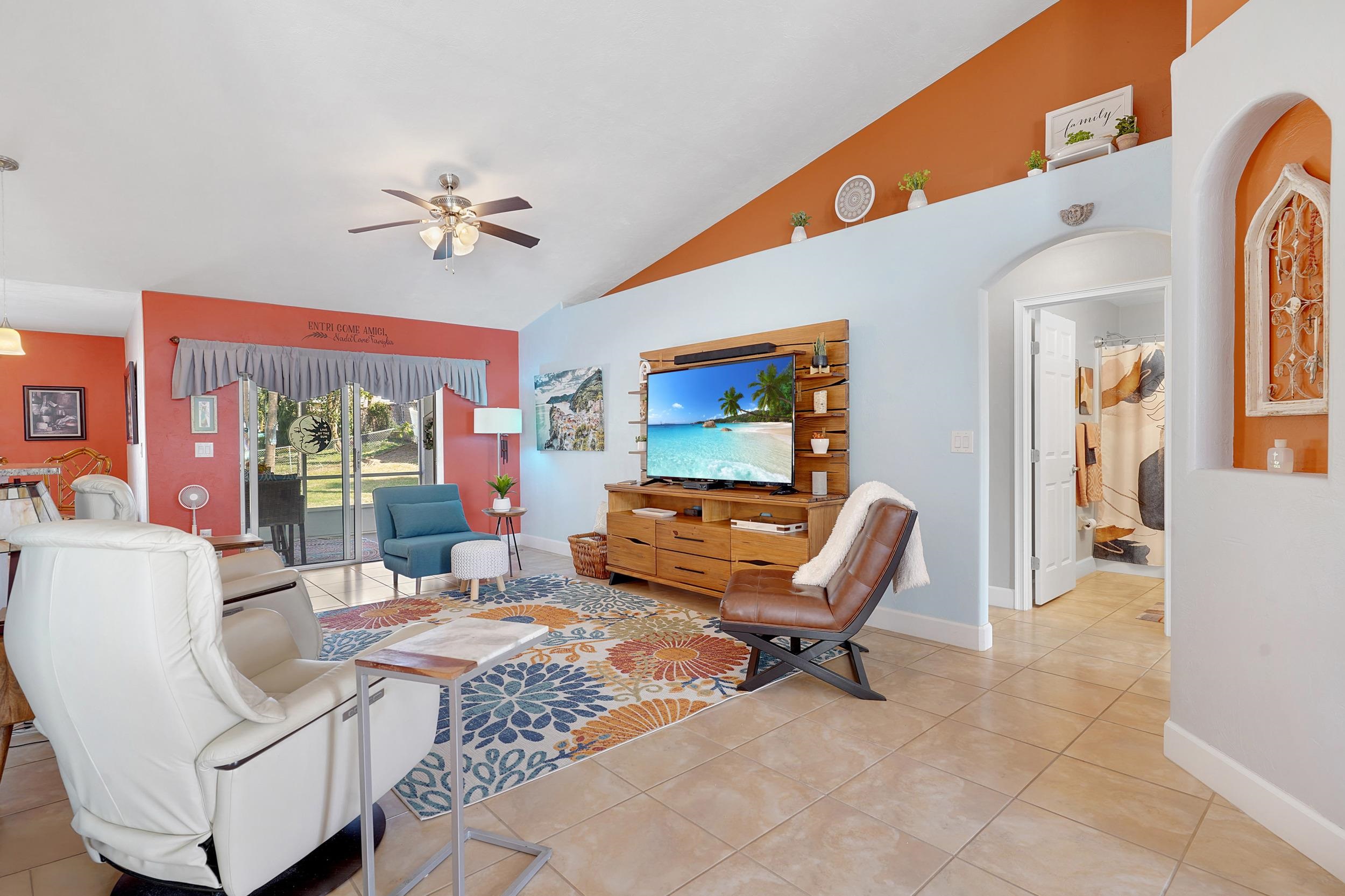 121 Harrison Road Daytona Beach, FL 32118 - Photo 9 of 48 a living room with furniture a rug and a floor to ceiling window