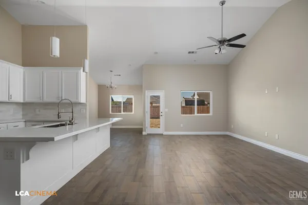 a view of kitchen with sink and wooden floor