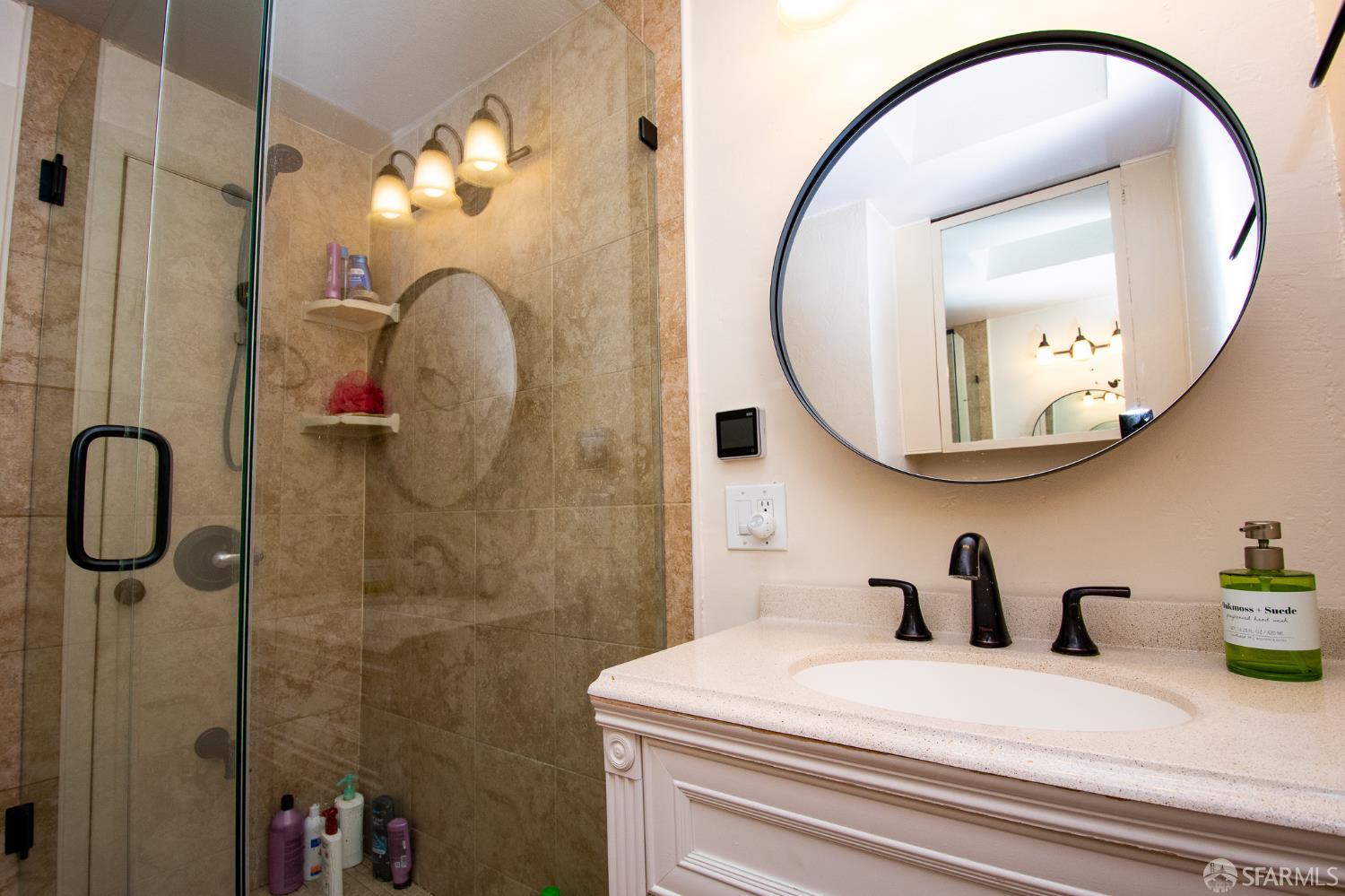 40 Encina Avenue Monterey, CA 93940 - Photo 17 of 23 a bathroom with a sink mirror and vanity