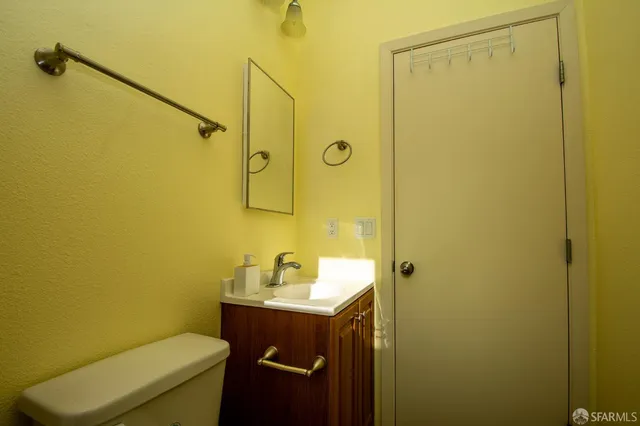 a bathroom with a sink mirror toilet and shower