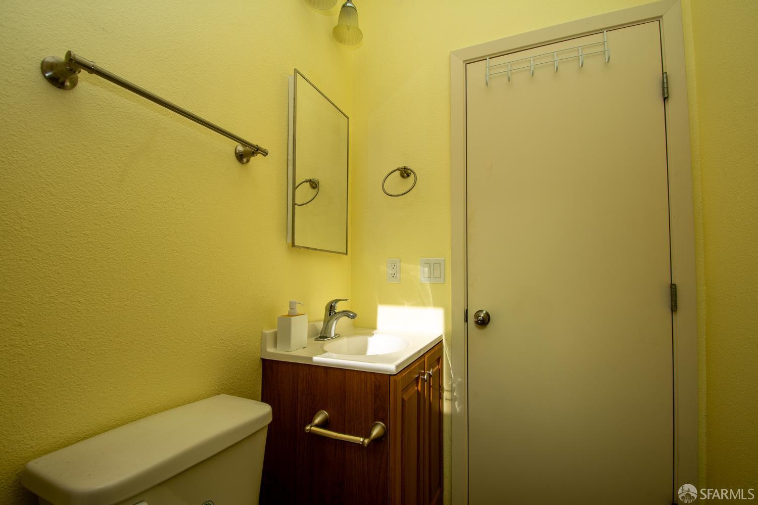 40 Encina Avenue Monterey, CA 93940 - Photo 19 of 23 a bathroom with a sink mirror toilet and shower