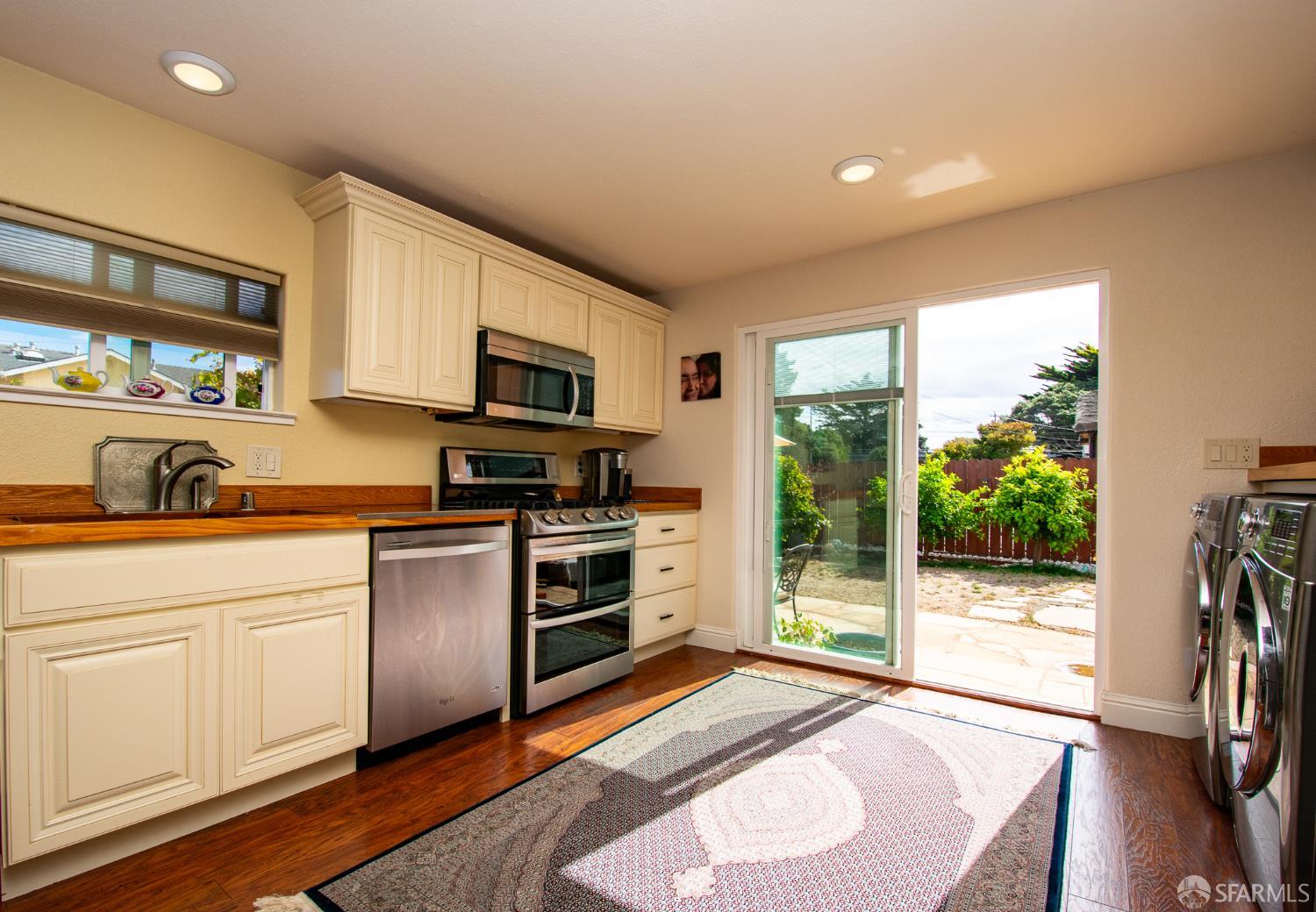 40 Encina Avenue Monterey, CA 93940 - Photo 4 of 23 a kitchen with granite countertop a stove a sink and a refrigerator