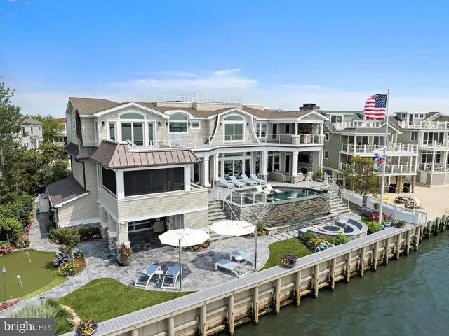 a front view of a house with swimming pool having outdoor seating