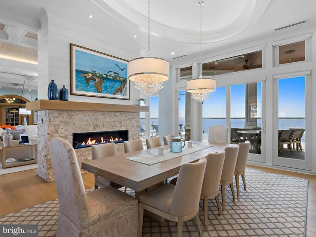 a kitchen with stainless steel appliances a stove a sink a oven a kitchen island with chairs and cabinets