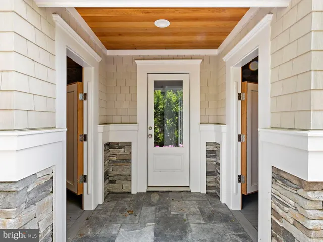 a bedroom with a bed and a dresser with mirror