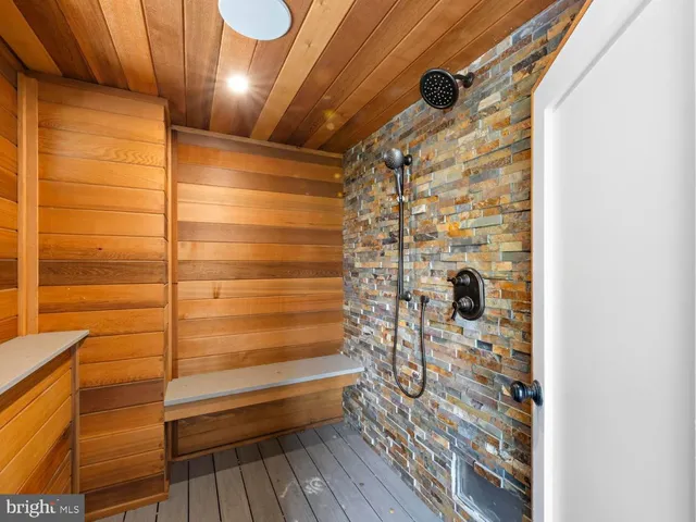 a bathroom with a sink a toilet a mirror and shower