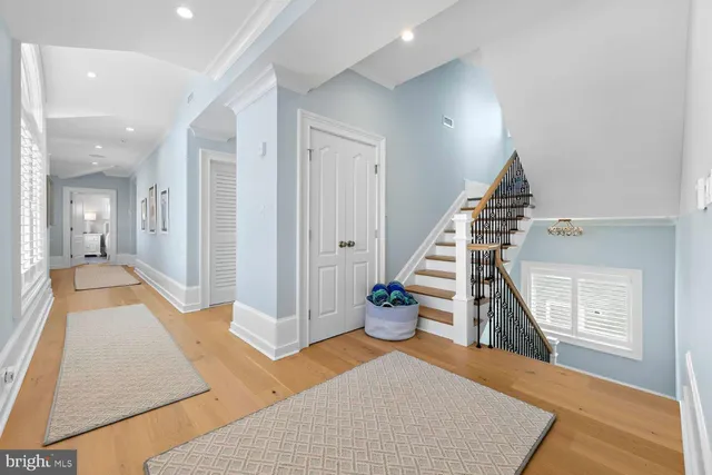 a large bedroom with bed and a chandelier