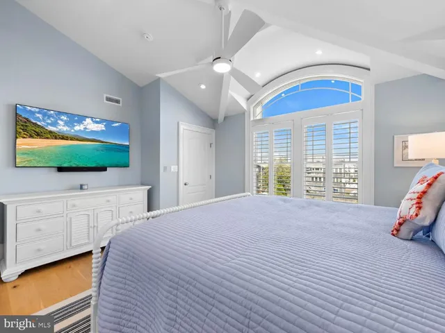 a white bath tub sitting in a bathroom next to a window
