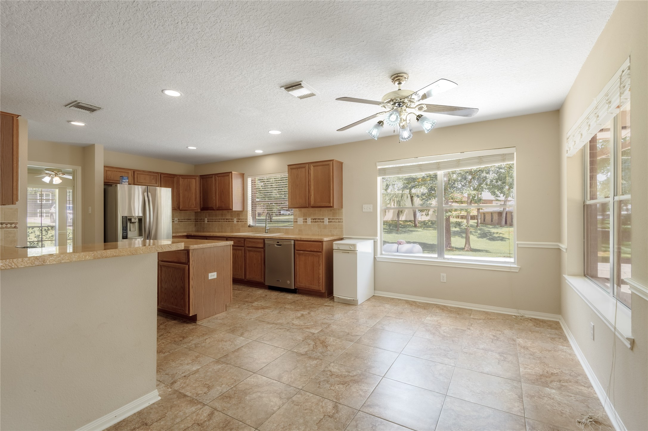 324 Red Oak Lane Trinity, TX 75862 - Photo 18 of 49 a large kitchen with kitchen island granite countertop a stove a sink a counter space and cabinets