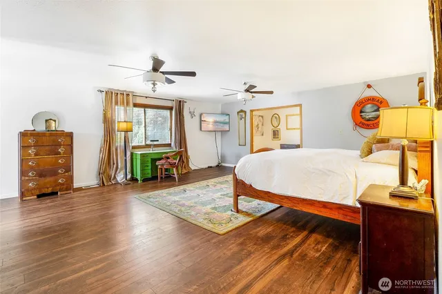 a bedroom with a bed dresser and a baby crib