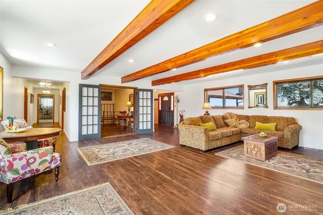 a living room with dining table and wooden floor